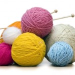colorful yarn balls with needles